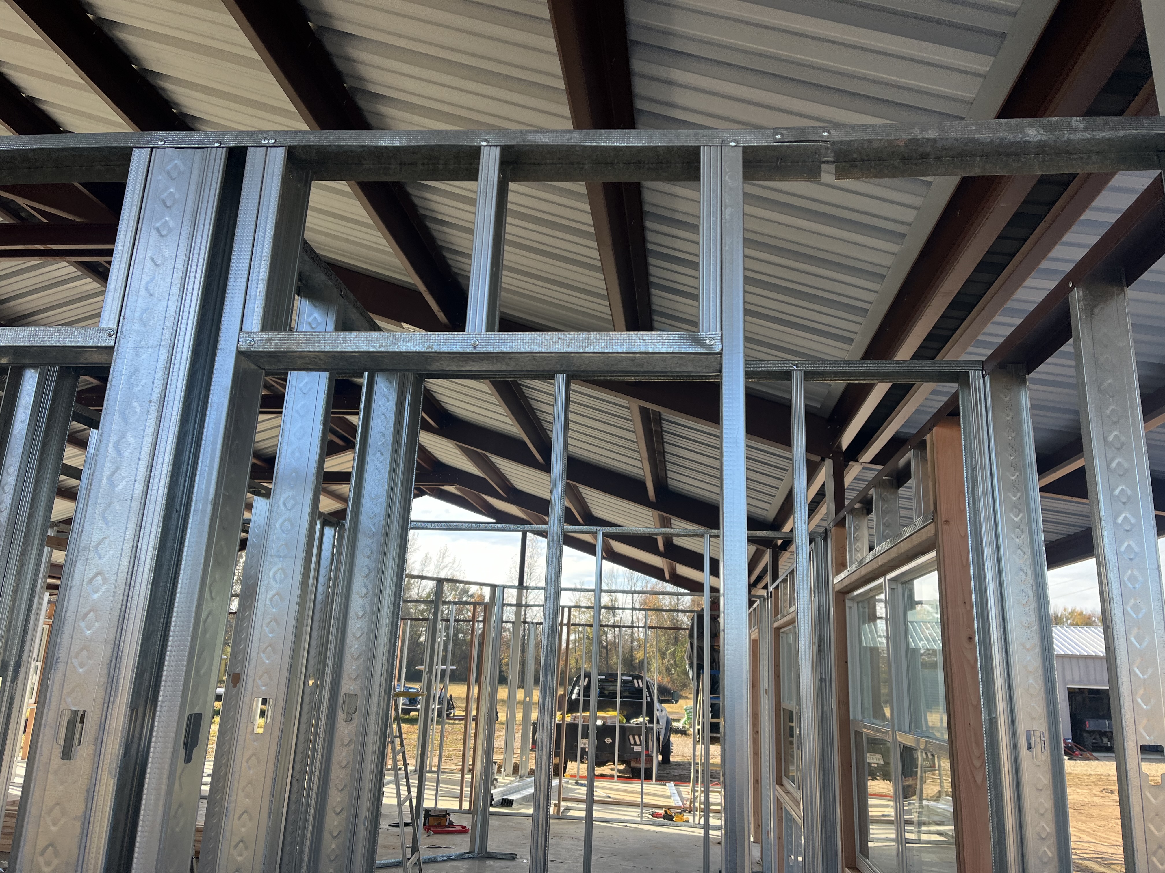 Metal building project photo with a finished wall and roof line