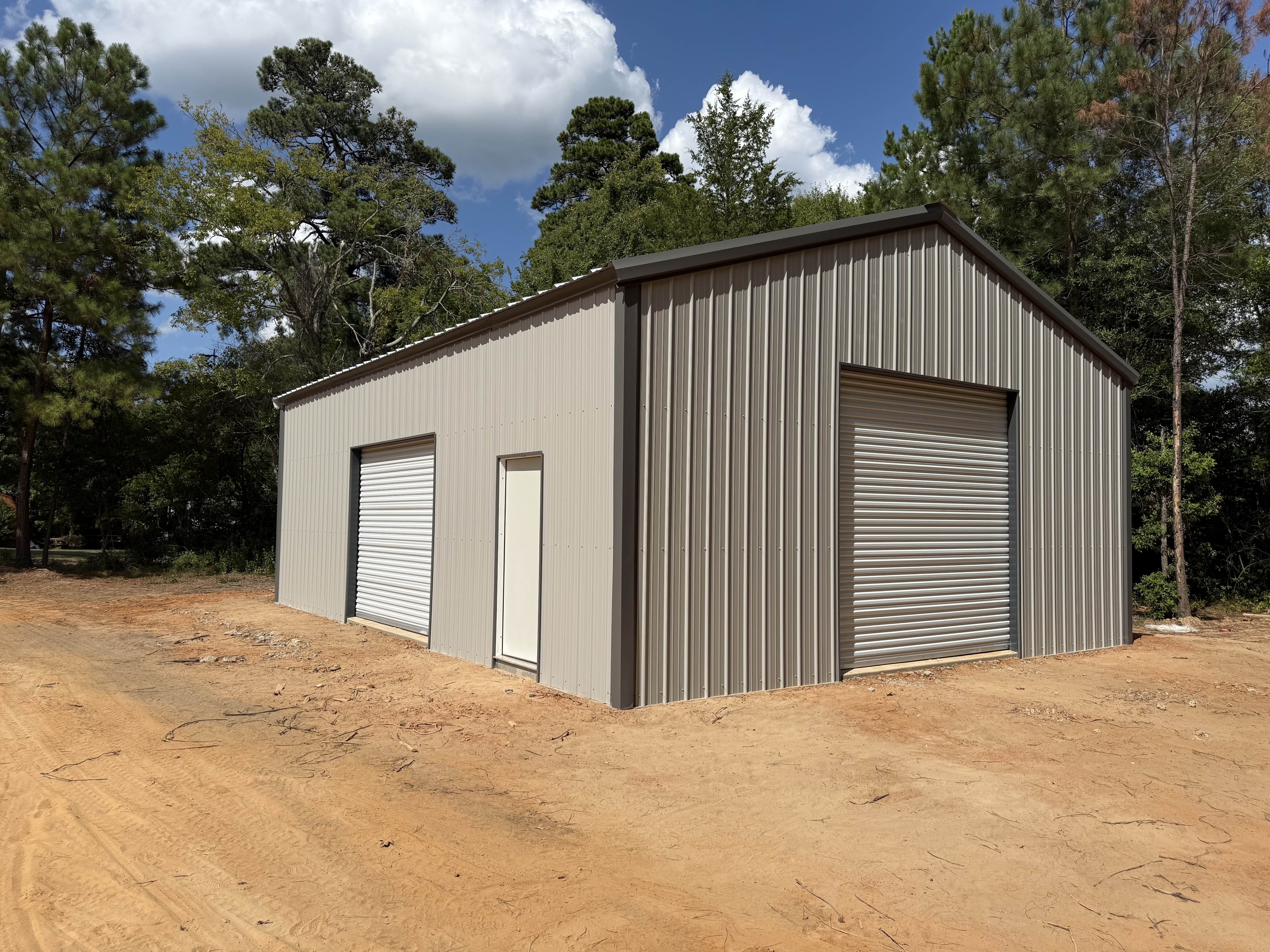 Finished metal building with siding and roof panels